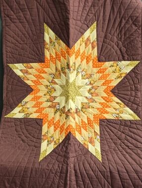 Brown Quilted Wall Tapestry with Yellow & Orange Starburst